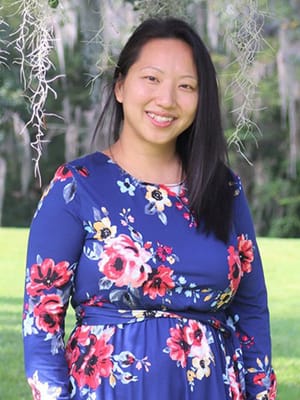 smiling woman in flower print dress