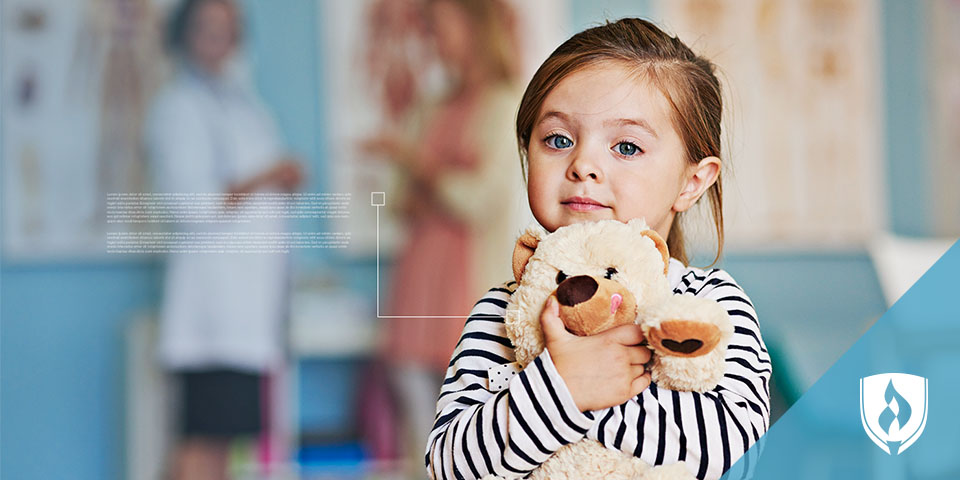 child holding a teddy bear