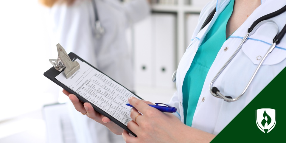 photo of a healthcare professional with a white coat holding a patient's chart