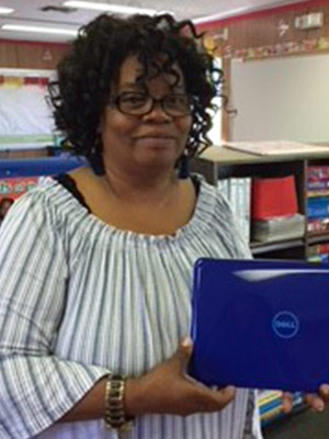 Deidra Boodoo holding a laptop