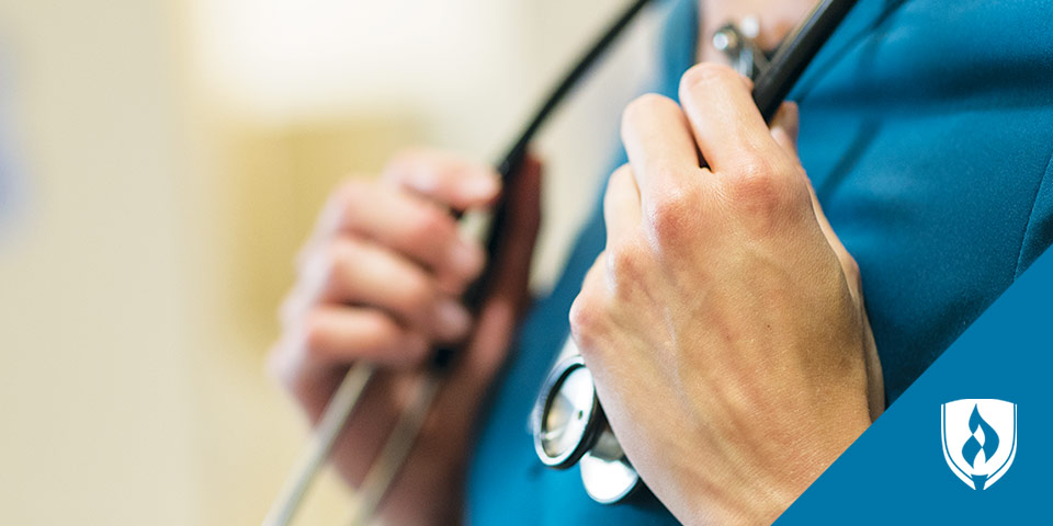 female nurse grabbing her stethoscope around her neck