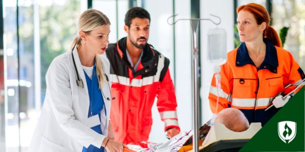 Two paramedics and a doctor bring a patient into the hospital