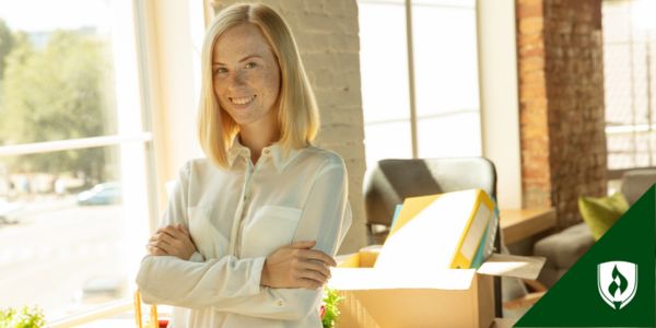 A corporate finance consultant folds her arms in front of a sunny office
