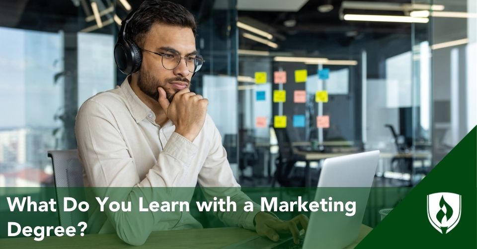 A marketing major works on his computer in a marketing office