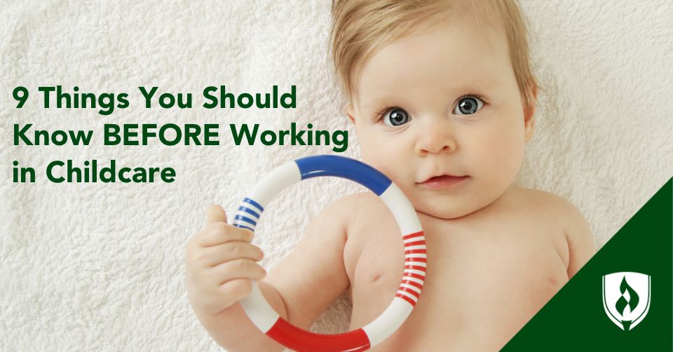 A sweet baby holds a toy ring on a white blanket