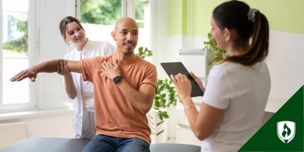 A physical therapy aide and assistant work with a patient