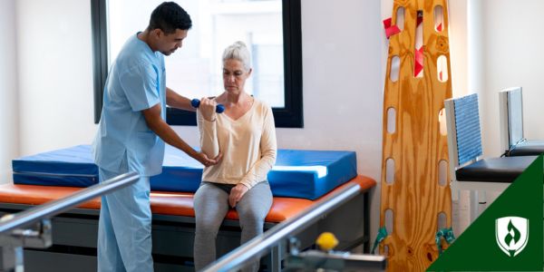 A PTA assists a patient with some arm movement exercises