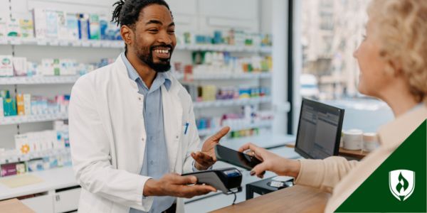 A pharmacy technician talks with a patient