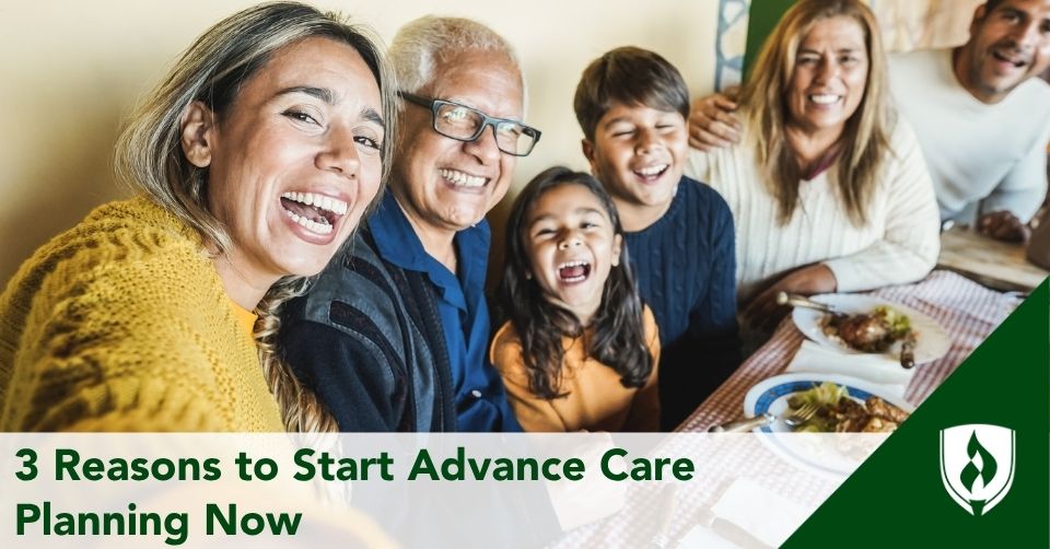 A happy family laughs around a dinner table