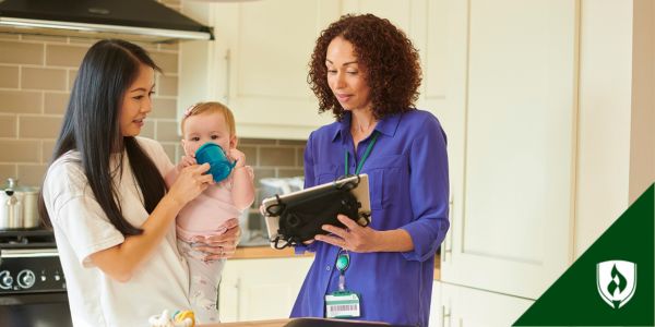 A social services assistant shows a young mother a list of resources