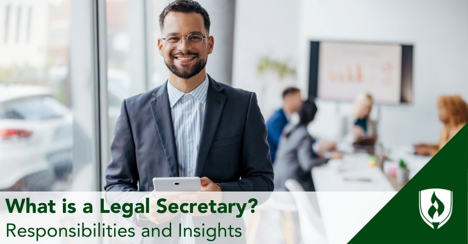 A legal secretary smiles, holding a tablet during a meeting