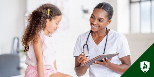 An LPN smiles at a young patient