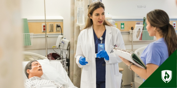 A nursing instructor explains the simulation parameters to a student