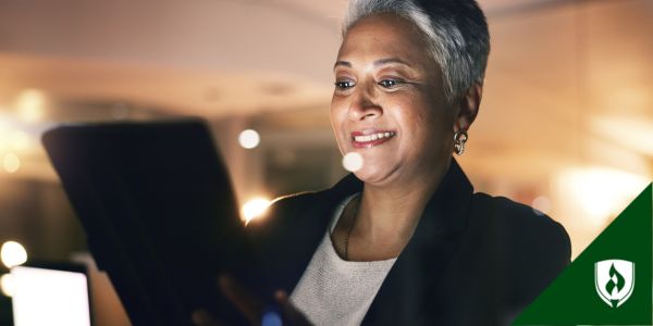 An information security analyst looking at a tablet in her office