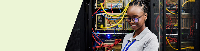 Network Systems Administrator holding a clipboard in a data center